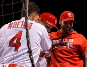 Sep 30, 2016; St. Louis, MO, USA;  St. Louis Cardinals pinch hitter Matt  Holliday (7) is congratulated by catcher Yadier  Molina (4) and starting pitcher Adam  Wainwright (50) as he enters the dugout after hitting a solo home run during the seventh inning against the Pittsburgh Pirates at Busch Stadium. Mandatory Credit: Scott Kane-USA TODAY Sports